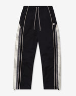 BLACK::A black Undefeated paneled Track Pant on a white background.