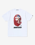 WHITE::A white Undefeated and Bape t-shirt on a white background.