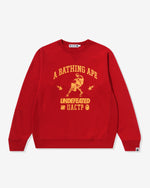 RED::A red Bape crewneck sweatshirt on a white background.